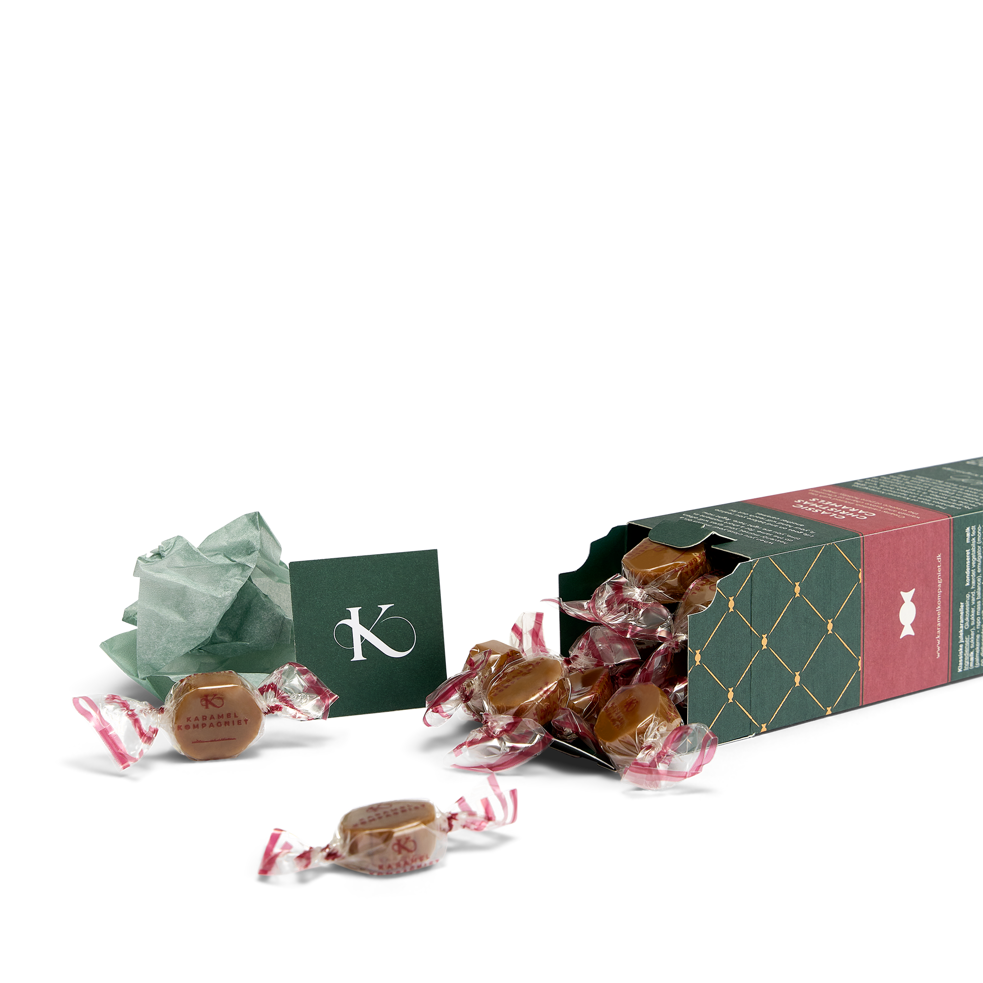 Klassiske Julekarameller elegance-æske fra Karamel Kompagniet liggende ned med karameller flydende ud