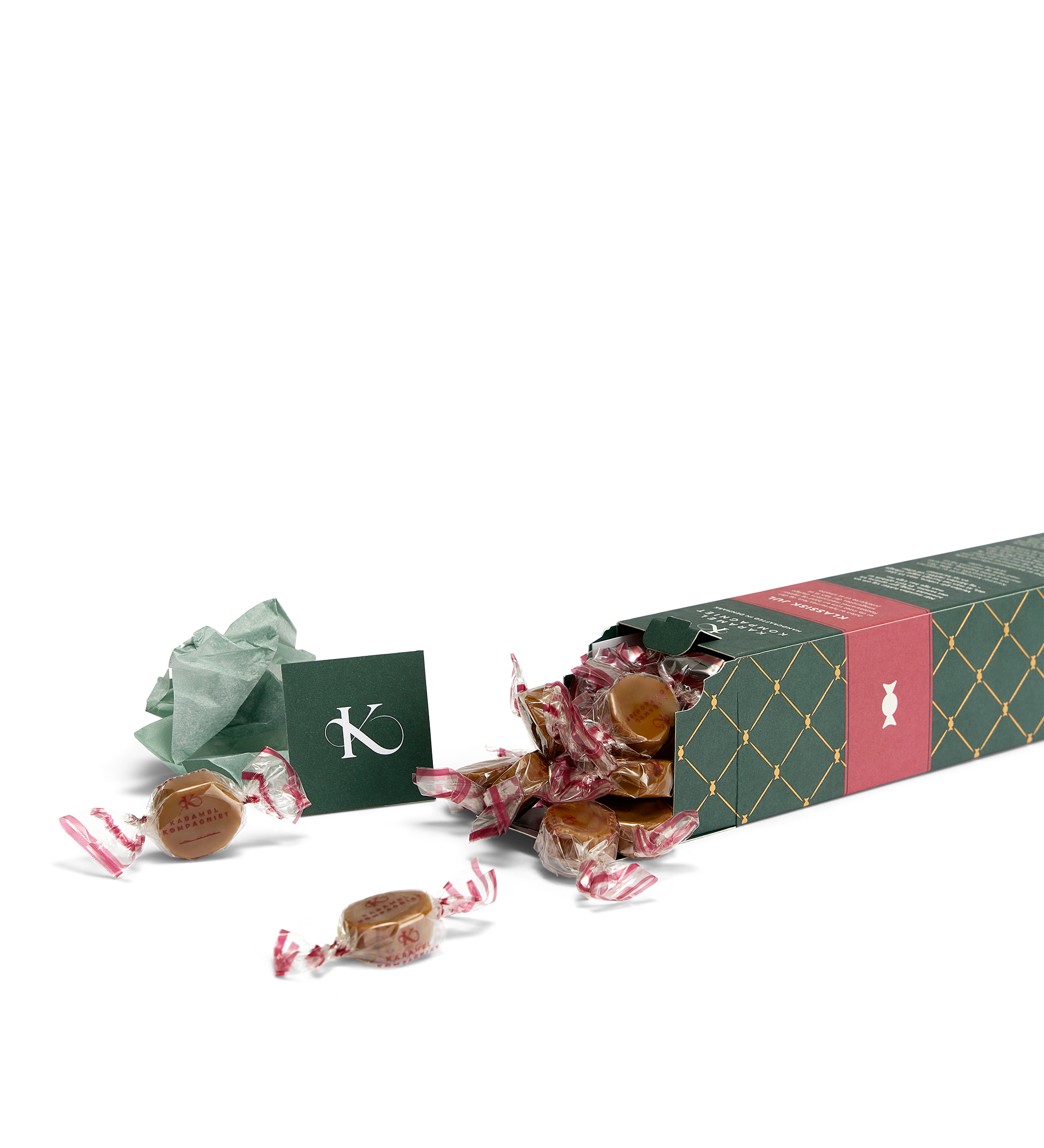 Klassiske Julekarameller highlight-æske fra Karamel Kompagniet liggende ned med karameller flydende ud